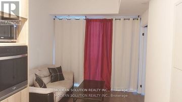 Toronto (Waterfront Communities) condo for rent - A living room with a couch and a television.