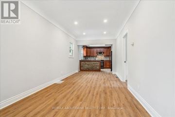 Hamilton (Raleigh) apartment for rent - A spacious room with wooden flooring and a kitchen area in the background.
