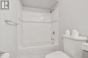 Hamilton (Raleigh) apartment for rent - A white bathroom with a tub, toilet and sink.