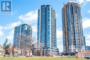 Kitchener condo for rent - Three high-rise buildings are under construction in a sunny suburban area.