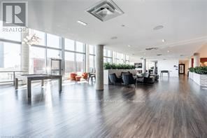 Kitchener condo for rent - A spacious living room with a dining table and chairs.
