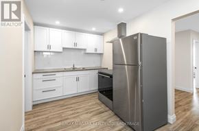 Port Colborne (Sugarloaf) apartment for rent - A modern kitchen with a stainless steel refrigerator.
