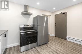 Port Colborne (Sugarloaf) apartment for rent - A kitchen with a stainless steel refrigerator and oven.