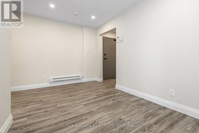 Port Colborne (Sugarloaf) apartment for rent - A room with a wooden floor and a door leading to another room.