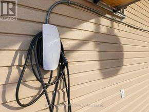 Aurora apartment for rent - A white Tesla Powerwall is mounted on a house wall.