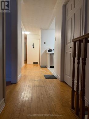 Hamilton (Kentley) apartment for rent - A hallway with wooden floors and white walls.