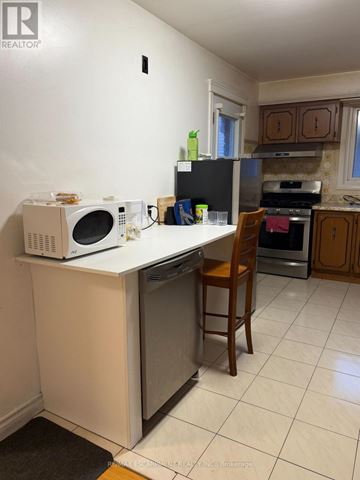 Hamilton (Kentley) apartment for rent - A kitchen with a white counter top and a black refrigerator.