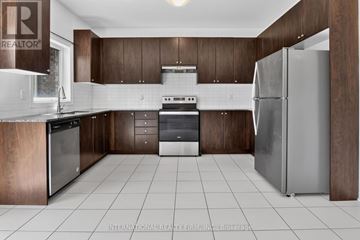 Southgate apartment for rent - A modern kitchen with dark wood cabinets and stainless steel appliances.