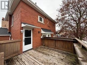 St. Thomas apartment for rent - A red brick house with a white door and a wooden deck.