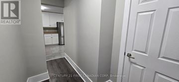 St. Thomas apartment for rent - A hallway with a door on the right and a kitchen in the background.