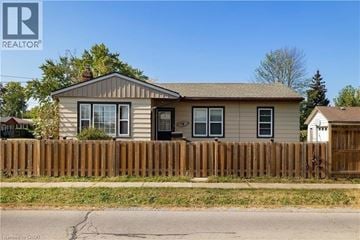 St. Catharines apartment for rent - A house with a brown fence in front of it.