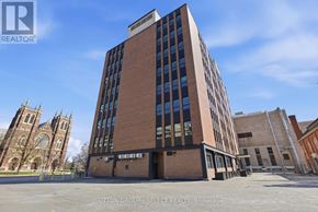 London East (East F) condo for rent - A tall building with a glass facade is the main focus of the image.
