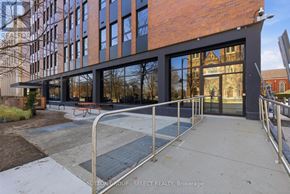 London East (East F) condo for rent - A modern building with a glass facade and a metal railing in front.