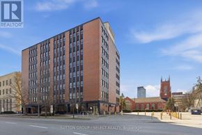 London East (East F) condo for rent - A tall brick building with many windows is for sale.