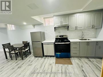 Brampton (Credit Valley) apartment for rent - A kitchen with a table and chairs and a fridge.