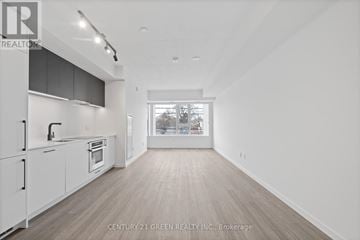Toronto (Stonegate-Queensway) condo for rent - A spacious kitchen with white cabinets and a window.