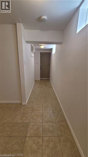 Hamilton apartment for rent - A hallway with tiled flooring and white walls.