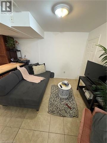 Hamilton apartment for rent - A living room with a grey couch and a black television.