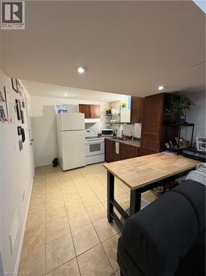 Hamilton apartment for rent - A kitchen with a refrigerator, oven, and microwave.