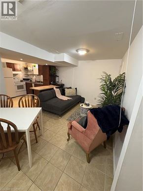 Hamilton apartment for rent - A living room with a couch, chairs, and a dining table.