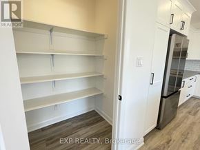 Mcnab/Braeside multi-family for rent - Empty white shelves in a kitchen with EXP Realty, Brokerage watermark.