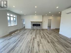 Mcnab/Braeside multi-family for rent - A spacious room with wood flooring and a fireplace.