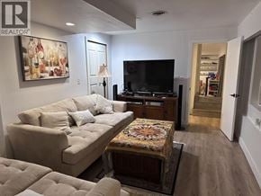 West Vancouver apartment for rent - A living room with a beige couch and a television.