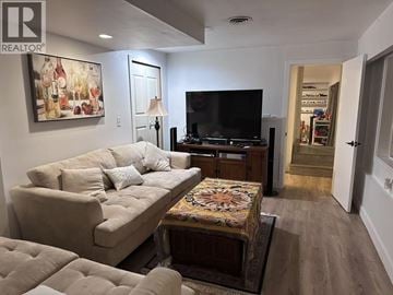 West Vancouver apartment for rent - A living room with a beige couch and a television.