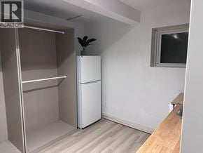 West Vancouver apartment for rent - A small room with a white fridge and a small plant on top of it.