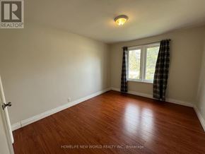 Richmond Hill (Crosby) apartment for rent - A room with wooden flooring and a window with curtains.