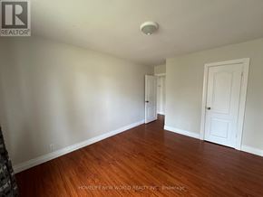 Richmond Hill (Crosby) apartment for rent - A room with wooden floors and white walls.