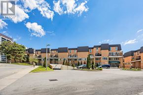 Toronto (Morningside) townhouse for rent - A large building complex with a parking lot in front.