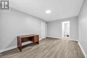 Toronto (Morningside) townhouse for rent - A room with a wooden table and light grey walls.