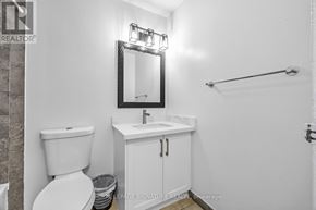 Toronto (Morningside) townhouse for rent - A white bathroom with a toilet, sink, and mirror.