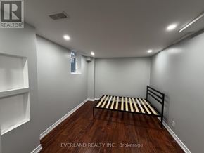 Richmond Hill (Rouge Woods) apartment for rent - A bedroom with a bed, shelves, and a window.