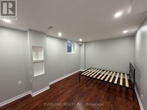 Richmond Hill (Rouge Woods) apartment for rent - A bedroom with Everland Realty Inc. logo on the wall.