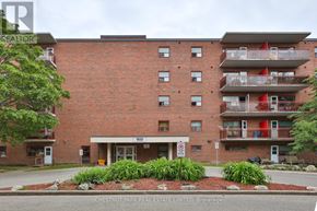 Oshawa (Lakeview) condo for rent - A red brick building with a white entrance and a sign that says 900.