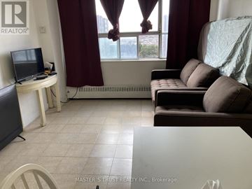 Toronto (Yorkdale-Glen Park) condo for rent - A living room with a couch, television, and window with curtains.
