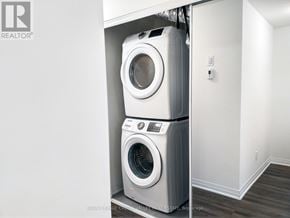 Mississauga (Mineola) townhouse for rent - A washer and dryer are stacked on top of each other in a small laundry room.
