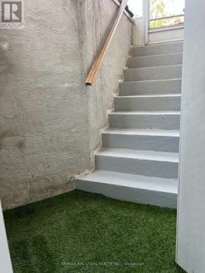 Pickering (Amberlea) apartment for rent - A staircase with a wooden handrail and concrete steps.