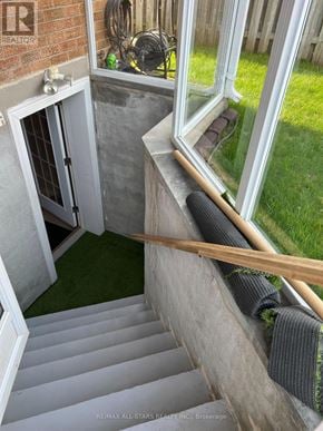 Pickering (Amberlea) apartment for rent - A staircase with a window above it and a door to the left.