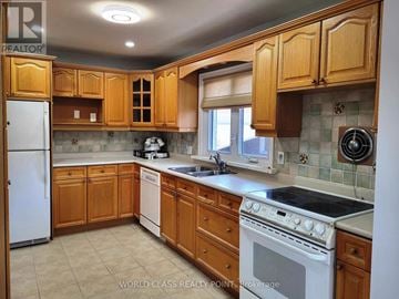 Toronto (Bendale) apartment for rent - A kitchen with wooden cabinets and a white refrigerator.