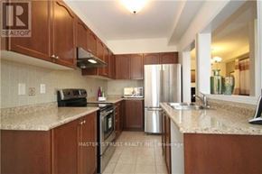 Vaughan (Patterson) apartment for rent - A kitchen with brown cabinets and a black toaster on the counter.