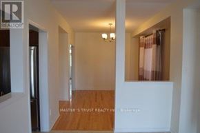 Vaughan (Patterson) apartment for rent - A room with a white wall and a wooden floor.