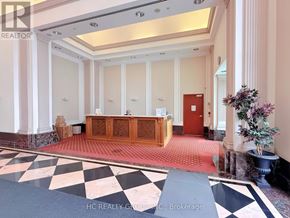 Toronto (Woburn) condo for rent - A reception area with a checkered floor and a red door.