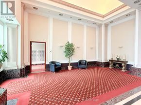 Toronto (Woburn) condo for rent - A large room with a red carpet and a fireplace.