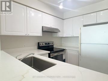 Toronto (Woburn) condo for rent - A kitchen with white cabinets and a stainless steel sink.