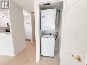 Toronto (Woburn) condo for rent - A white washer and dryer in a small room.