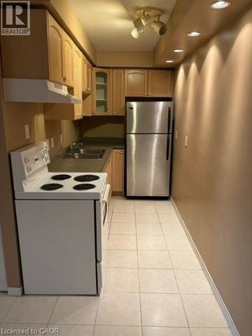 Hamilton condo for rent - A kitchen with a white stove top oven and a silver refrigerator.