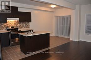 Markham (Greensborough) townhouse for rent - A modern kitchen with dark brown cabinets and a stone backsplash.
